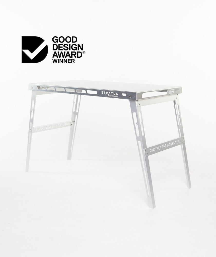 Side view of Good Design Award winner DEREK Camp Table showing brushed aluminium top, towel rail and wine opener built into the frame.