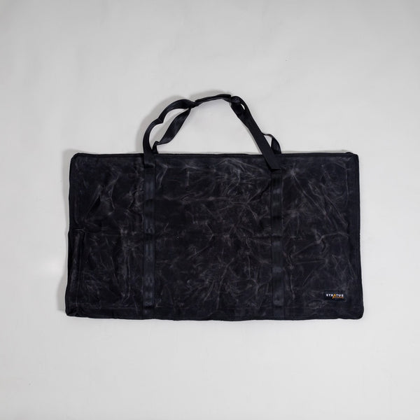 DEREK Camp Table in folded/packed mode inside its carry bag, demonstrating portability and compact storage.