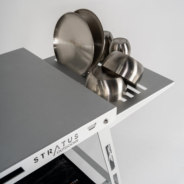 Stratus Outdoors Sink Rack attached to camp table with drying dishes and outdoor gear around.